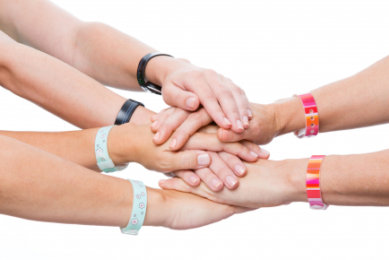 Hands overlapping with all wearing Psi Bands